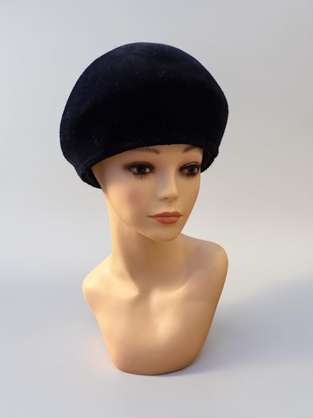 Vintage black plush structured bump hat, characteristic of mid-century fashion